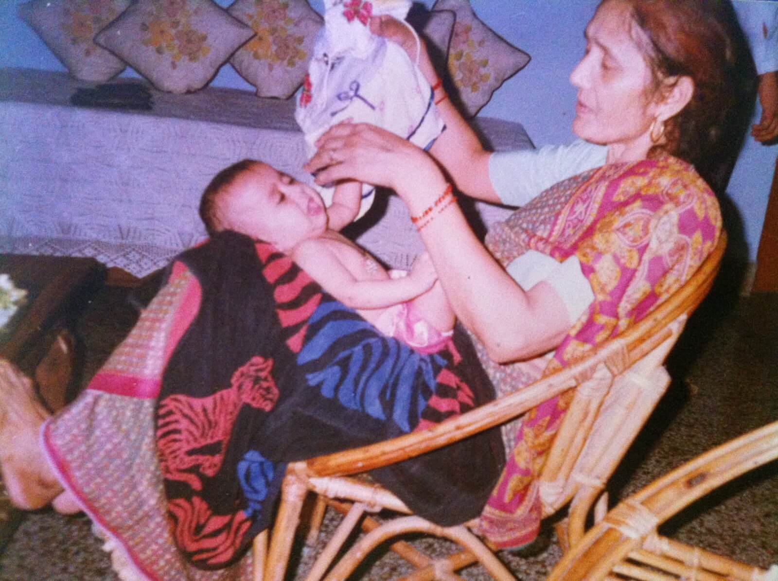 Image of a baby in the lap of their grandmother